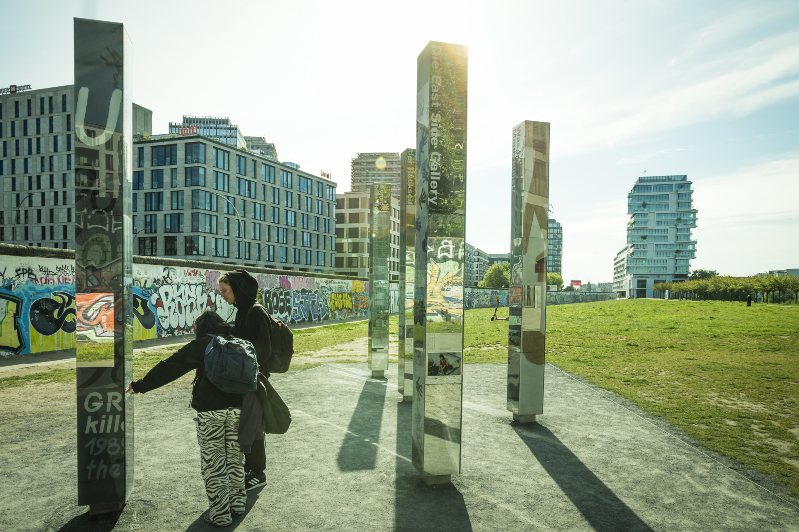 Visitors between the information pillars at the East Side Gallery